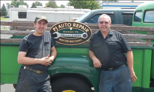 photo of Ray and Sam Jadzak from PJ Auto Repair in front of their greeen 1954 International Pickup Truck