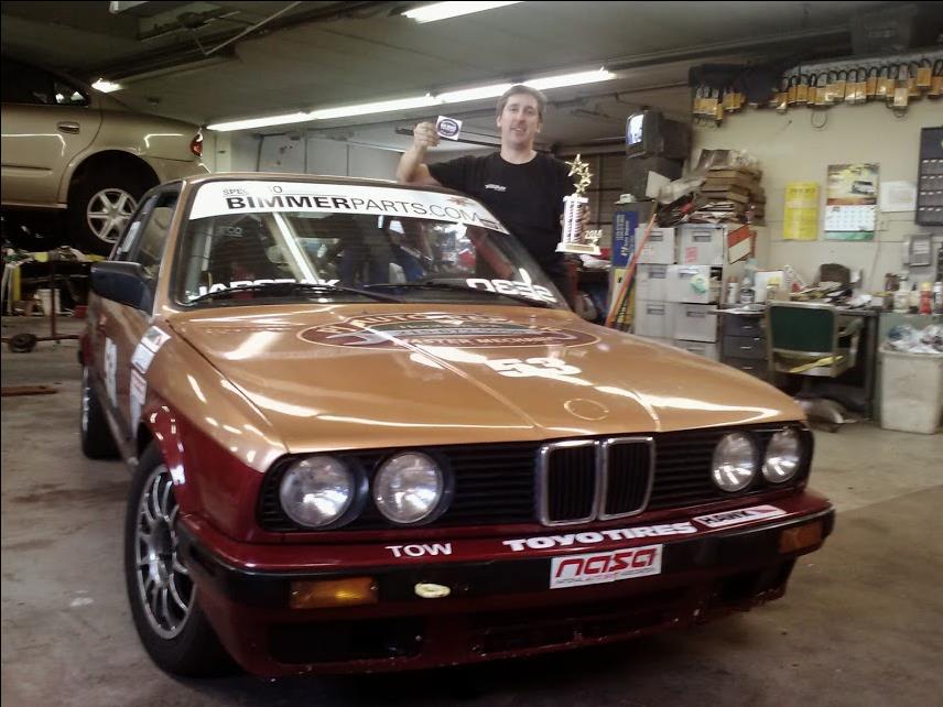 photo of Sam with trophy and BMW 325i